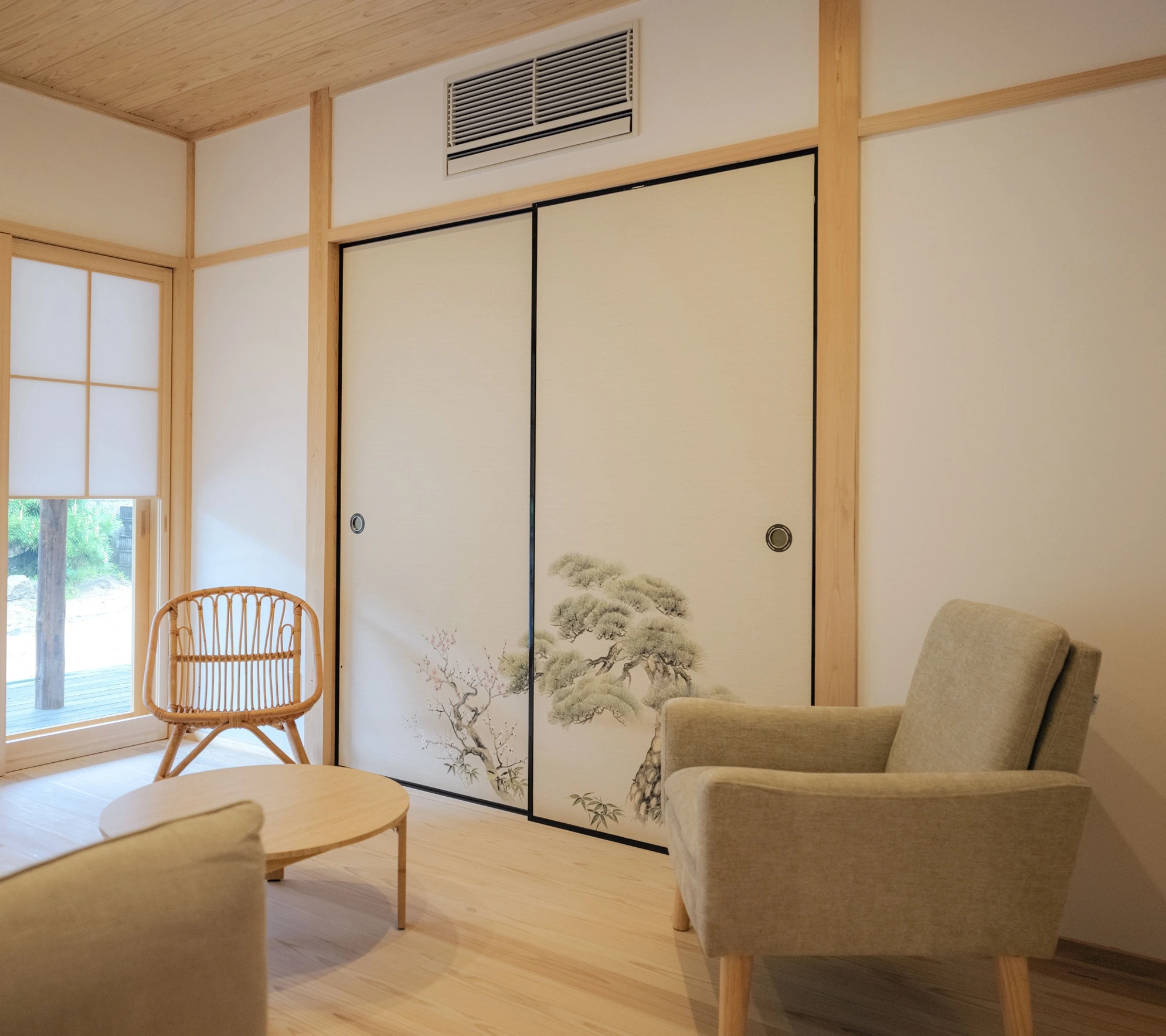 The restored interior, painted fusuma panels beside a shoji screen and a pale timber floor